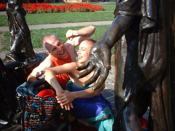 two people dancing between statues neil and christina at butoh fest